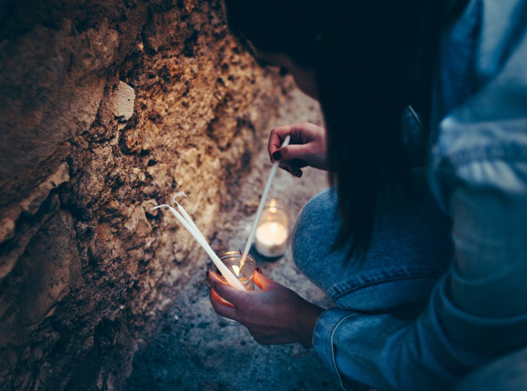 Woman lights candles - Hector Martinez